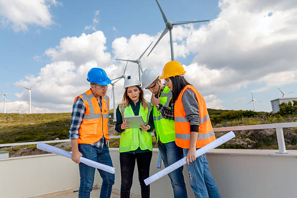 istock Engineers and Architects Collaborating with Digital Tablet at a Wind Farm for Renewable Energy and Sustainability Projects 2244147041
