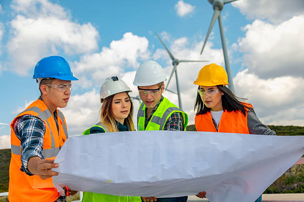 istock Engineers and Architects Analyzing Blueprints and Communicating at a Wind Farm for Renewable Energy and Sustainability Projects 2244147045