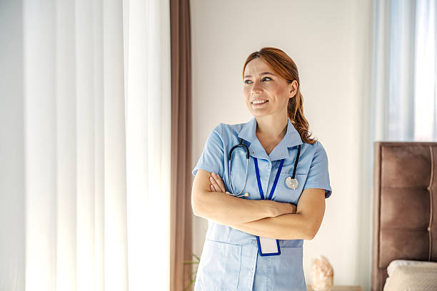 istock Female nurse standing confidently, looking away and smiling 2244147341