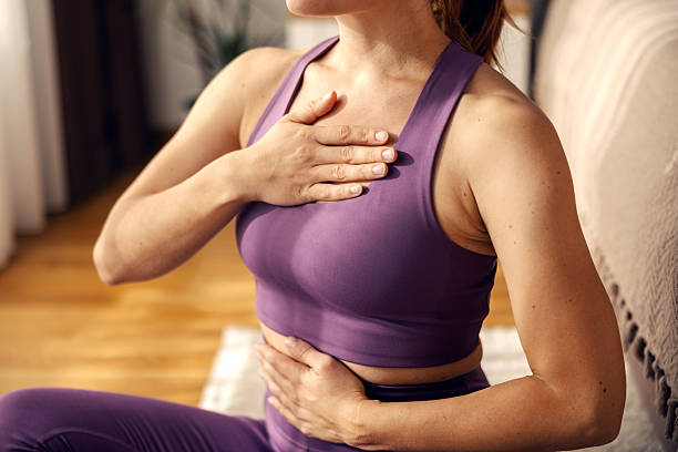 istock Woman practicing deep breathing exercise for wellness and relaxation 2244147596