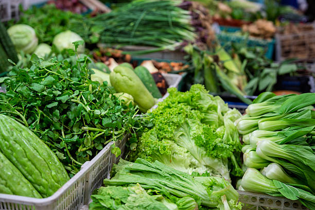 Fresh Leafy Greens and Vegetables Displayed at Local Market in Malaysia