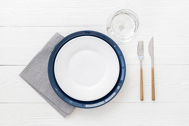 istock Table setting with empty plate and glass, cutlery and napkin, flat lay. Top view 2244149404