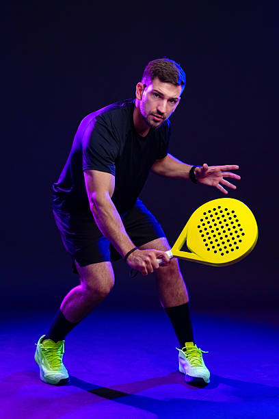 istock Competitive player prepares for a match in a vibrant setting with a yellow paddle 2244150076