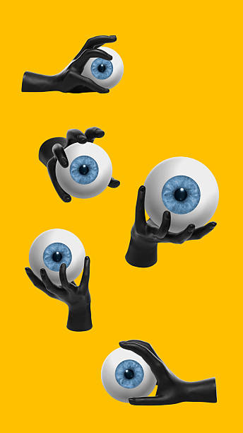 istock Black hands holding blue eyeballs on yellow background in surreal collage 2244152508