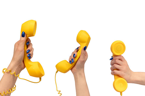istock Yellow handset in woman hand isolated on white. Copy space. 2244153631