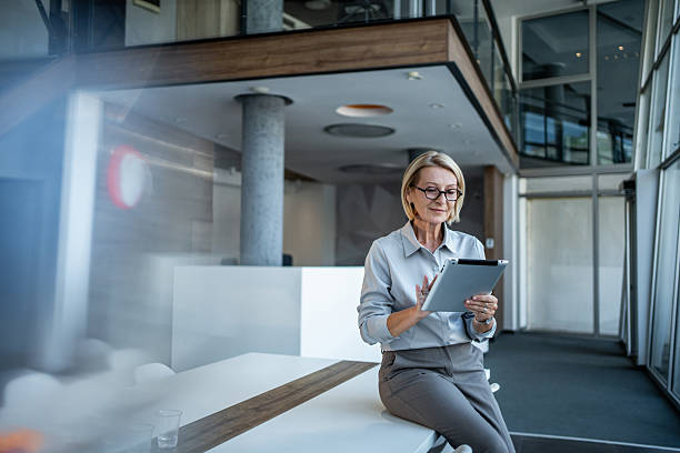 istock Businesswoman using digital tablet while sitting in modern office 2244153858
