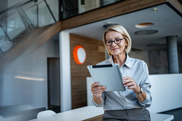 istock Mature businesswoman using digital tablet in modern office 2244153865
