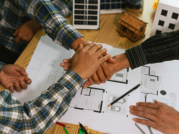 istock Close-up of engineer and architect shaking hands after completion of agreement, between construction workers wearing safety vests, teamwork cooperation on construction site. 2244154293