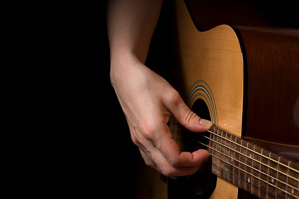 istock a girl plays the guitar 2244156460