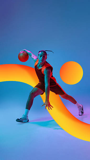 istock Modern collage. Basketball player dribbling with neon orange arc and glowing circle on gradient background 2244156632