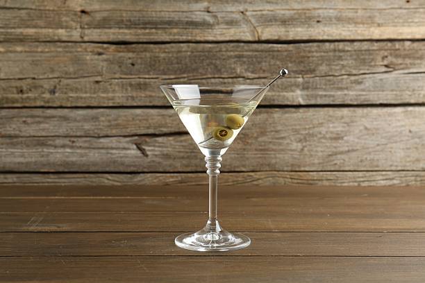 istock Martini cocktail with olives in glass on wooden table 2244157724