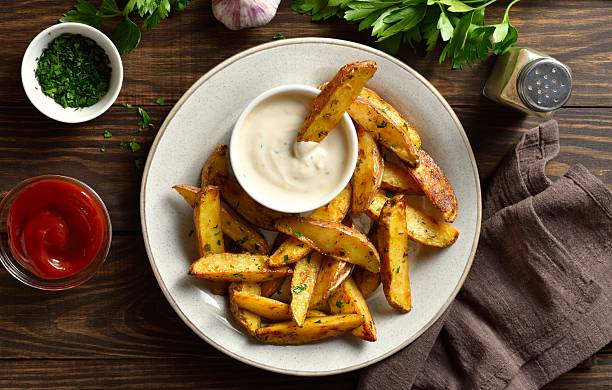 istock Baked potato wedges served with sauce 2244158395