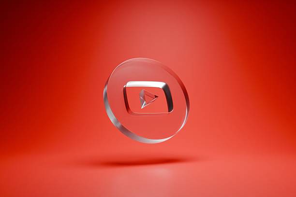 Reflective Glass YouTube Play Button Icon on a Gradient Red Background Symbolizing Online Video Content and Digital Media Streaming.
