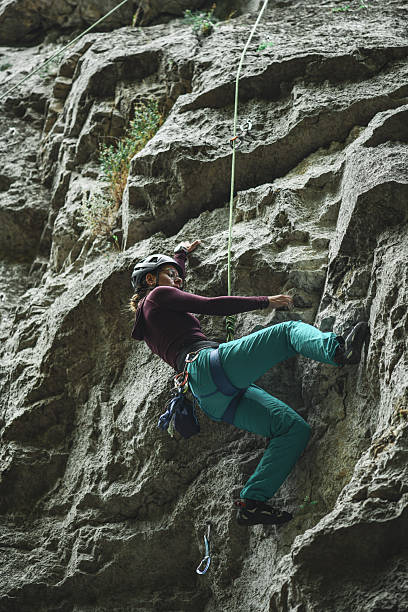 istock Climber Rock Climbing On Vertical Cliff With Harness And Rope Outdoors For Adventure And Fitness 2244161318