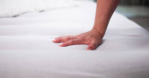 istock Young Man Trying Out A Soft Memory Foam Mattress 2244161717