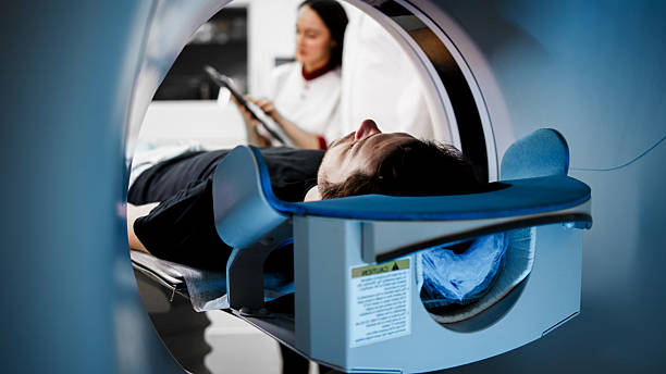 istock Patient undergoing CT scan in modern medical facility, with technician monitoring process, showcasing advanced imaging technology and healthcare environment 2244162755