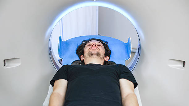 istock Patient lying on CT scanner table, preparing for tomography procedure, surrounded by advanced medical equipment, illustrating modern x-ray diagnosis technology and healthcare innovation 2244162774