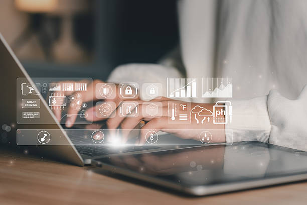 istock Business professional using laptop to manage smart farming IoT dashboard with AI data analytics, soil sensors, and weather monitoring, representing digital agriculture, automation, and sustainability. 2244163843