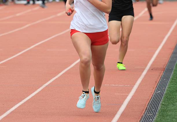 istock Female Runners Competing in a Relay Race at a Track Event 2244164576