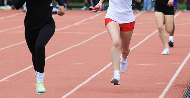istock Relay Race at Track Meet With Runners in Action 2244164600