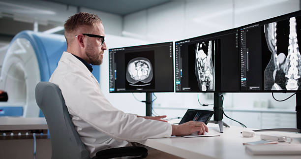 istock Young Male Surgeon Analyzing Lumbar MRI Scan 2244166313