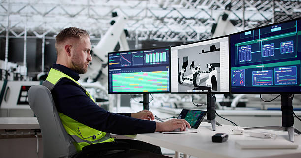 istock Factory Engineer Monitors Vehicle Production With Robotics 2244166370
