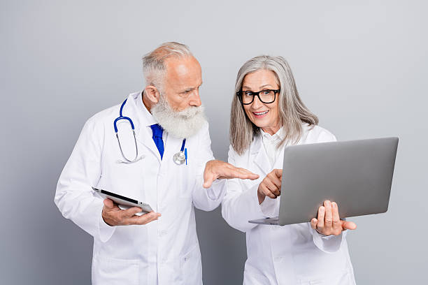 istock Two experienced doctors review patient data together in a clinic using tablet and laptop and discuss diagnosis and treatment 2244166975