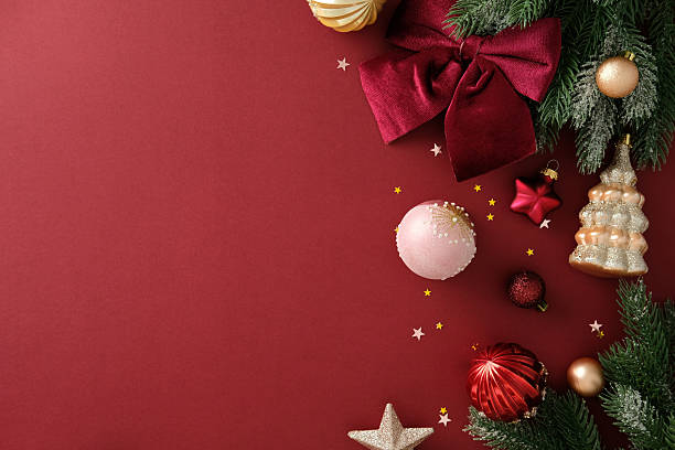 istock Christmas composition with velvet bow, bauble and pine branch on red background, holiday template with copy space. 2244167765