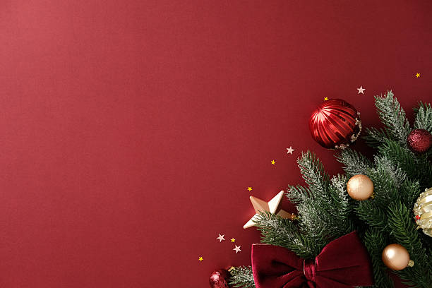 istock Holiday corner composition with pine branch, bauble, star and bow on red background, Christmas decoration template. 2244167861