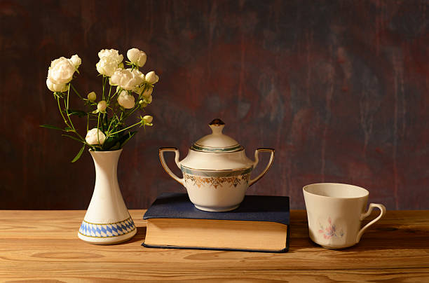 istock Still life, flowers in a ceramic vase, ceramic dishes and a book 2244170983