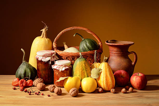 Still life, fruits, vegetables, wicker basket and ceramic jug on a wooden table