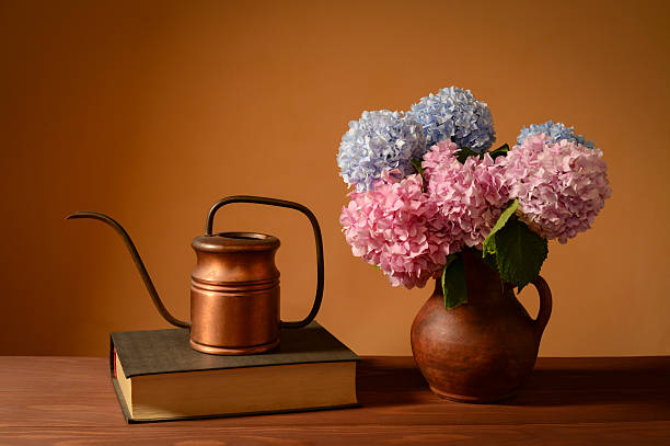 istock Still life, flowers in a ceramic vase, book and copper dishes 2244171056