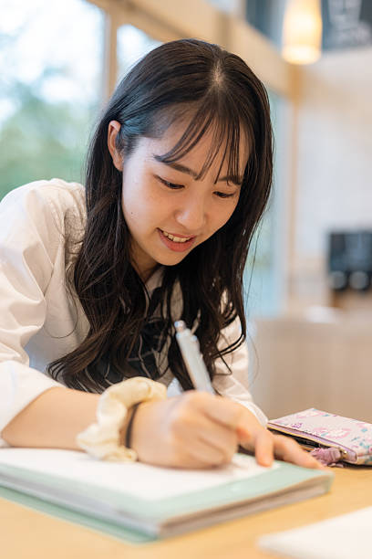Female high school student studying in cafe