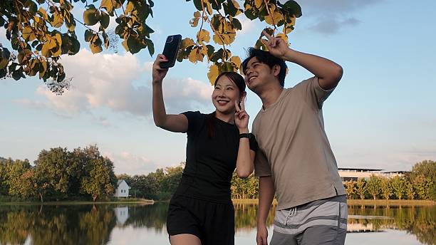 istock A couple is taking a selfie in front of a lake 2244174252