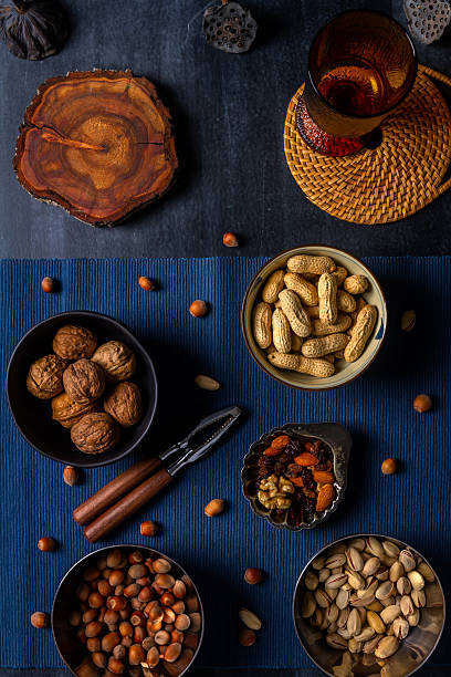 istock Bowls with nuts and blue table cloth on black chalkboard 2244174654