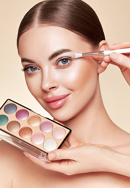 istock Makeup artist applies eye shadow 2244174797