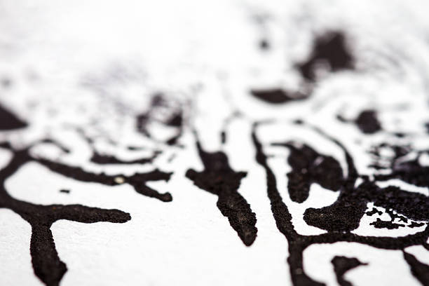 Extreme close up of black acrylic paint texture on paper. Selective focus.