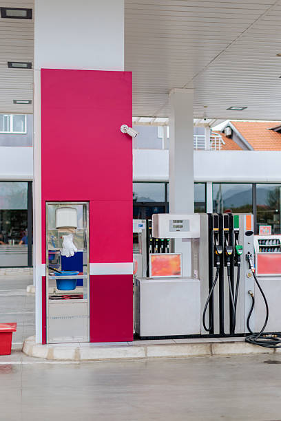 Contemporary gas station with multiple fuel dispensers, and visible safety equipment including fire extinguishers. The station appears well-maintained and ready for customers.