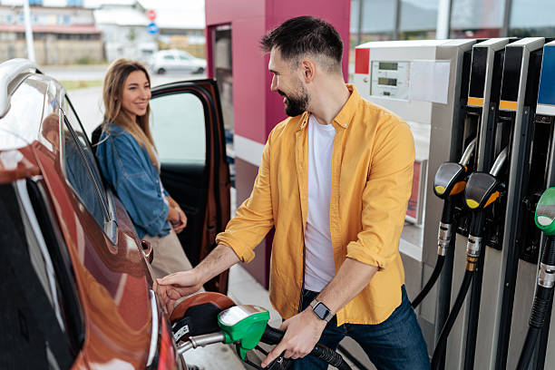 istock Couple Refueling Car at Gas Station 2244179023