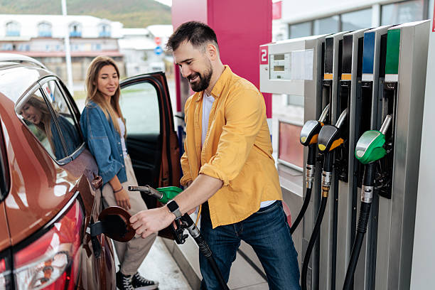 istock Couple Refueling Car at Gas Station 2244179045