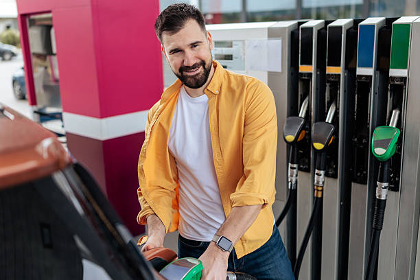 istock Smiling Man Refueling His Car at Gas Station 2244179163