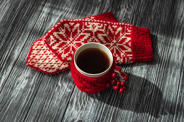 istock Festive Winter Coffee Scene with Knitted Cozy and Snowflake Mitten 2244179424