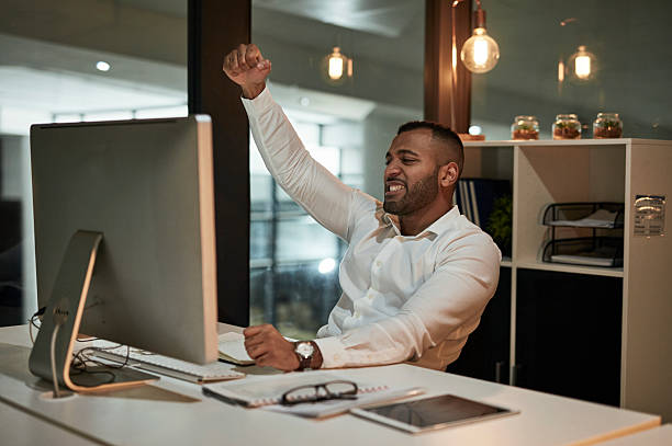 istock Energetic Office Celebration: Confident Professional Rejoices At Desktop Triumph 2244180044