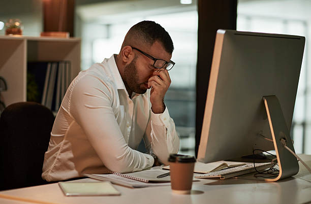 istock Tired Office Worker In White Shirt Struggles At Computer Desk In Modern Workspace 2244180073