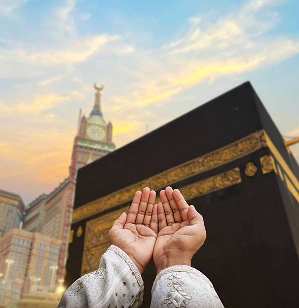 istock Hand of Muslim man praying with mosque background. 2244180906