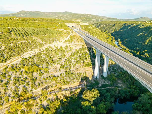 istock Modern highway bridge spanning a lush green valley 2244181973