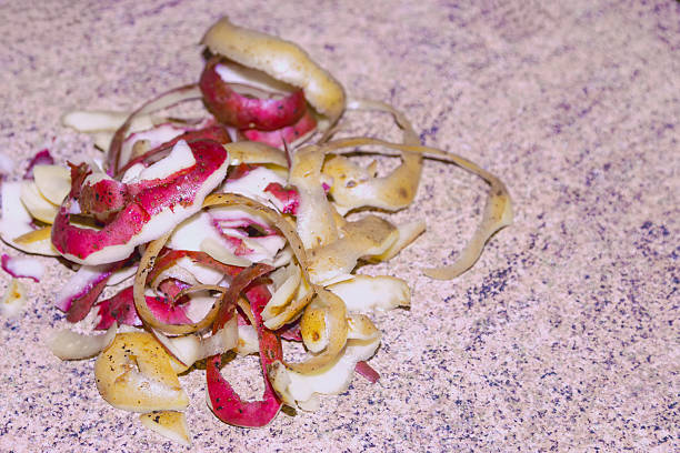 Potato peels on a kitchen table close-up. Food waste