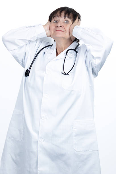 istock Stressed doctor covering ears feeling overwhelmed by workload 2244187961
