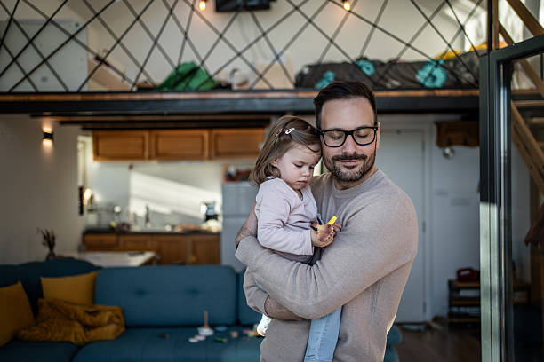 istock Father embracing toddler daughter at home 2244189199