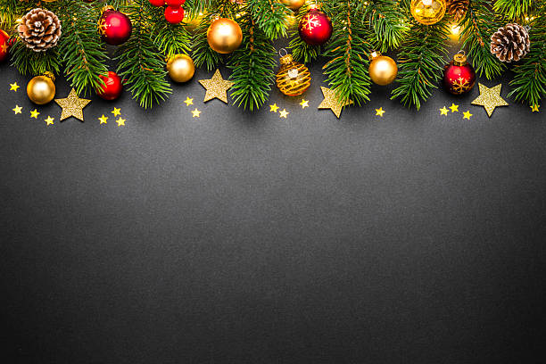 istock Flat lay of Christmas decoration border on dark background with copy space. Pine tree, baubles and star or copy space. Greeting card or frame 2244189214
